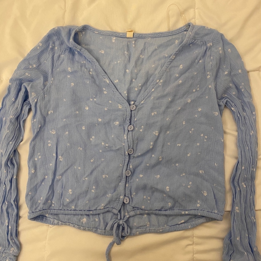 A lightweight light blue blouse with tiny white flowers